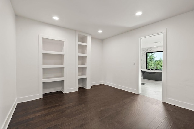 211 Whisper Ridge Dr, Bigfork, MT 59911 - spare room with wood finished floors, recessed lighting, and built in features