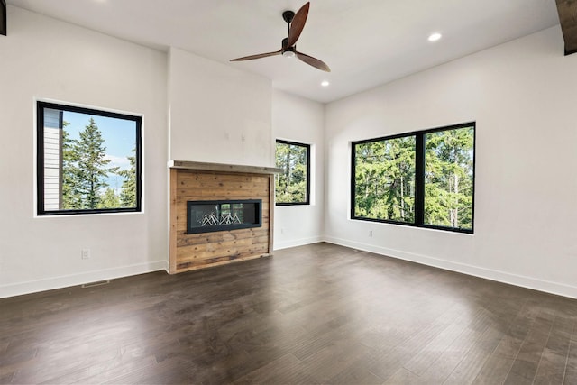 211 Whisper Ridge Dr, Bigfork, MT 59911 - unfurnished living room featuring a ceiling fan, recessed lighting, a glass covered fireplace, and dark wood finished floors
