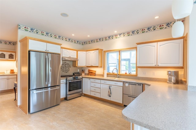286 Arbour Dr W, Kalispell, MT 59901 - kitchen featuring appliances with stainless steel finishes, under cabinet range hood, light countertops, recessed lighting, and white cabinetry