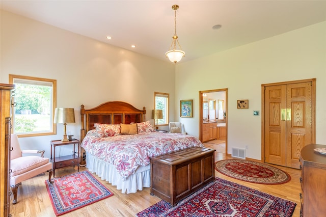286 Arbour Dr W, Kalispell, MT 59901 - bedroom with light wood finished floors, connected bathroom, a high ceiling, and recessed lighting