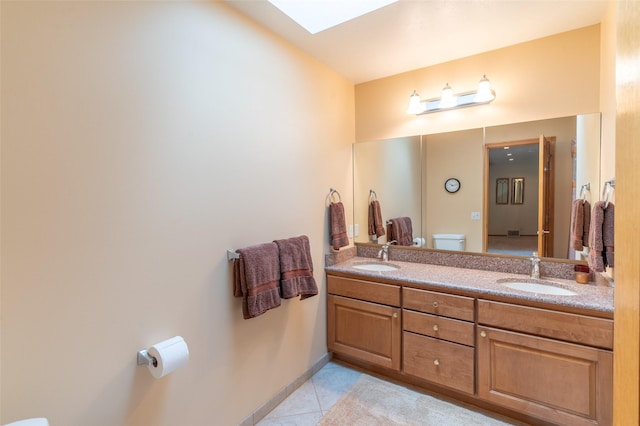 286 Arbour Dr W, Kalispell, MT 59901 - bathroom featuring a skylight, double vanity, and tile patterned floors