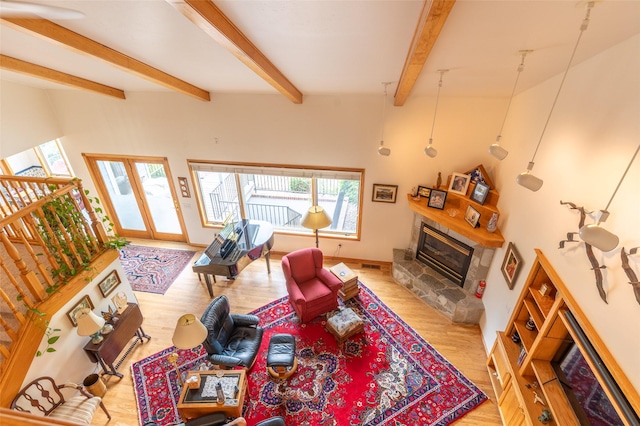 286 Arbour Dr W, Kalispell, MT 59901 - living area with a tile fireplace, beam ceiling, and light wood-style flooring