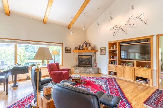 286 Arbour Dr W, Kalispell, MT 59901 - living room with wood finished floors, beamed ceiling, a fireplace, and high vaulted ceiling