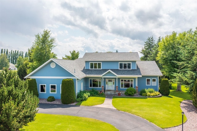 286 Arbour Dr W, Kalispell, MT 59901 - traditional-style home with a front lawn, a porch, and a shingled roof