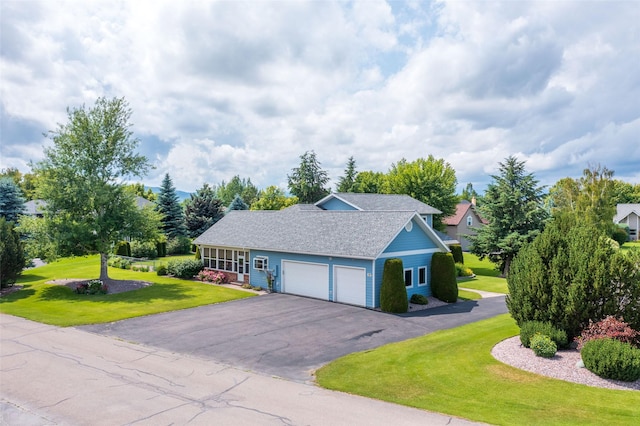 286 Arbour Dr W, Kalispell, MT 59901 - view of front facade featuring a front yard, a garage, asphalt driveway, and roof with shingles
