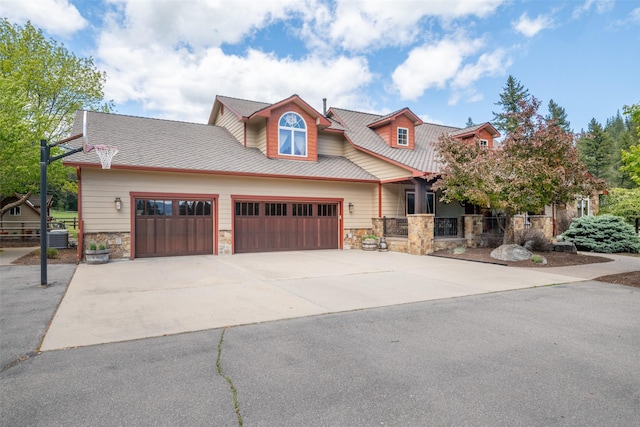9995 Obrien Creek Rd, Missoula, MT 59804 - view of front of property featuring an attached garage, stone siding, and driveway