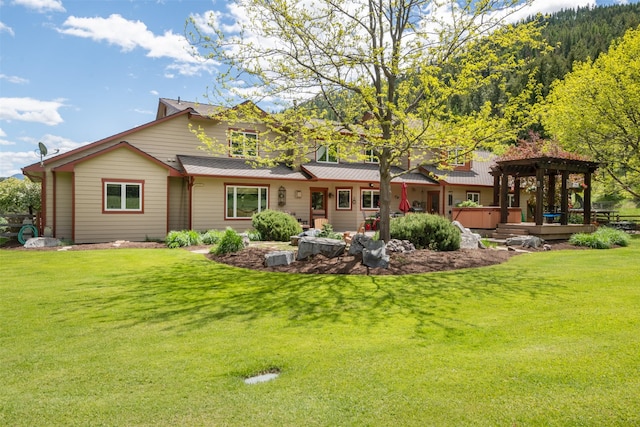 9995 Obrien Creek Rd, Missoula, MT 59804 - back of property featuring a hot tub and a lawn