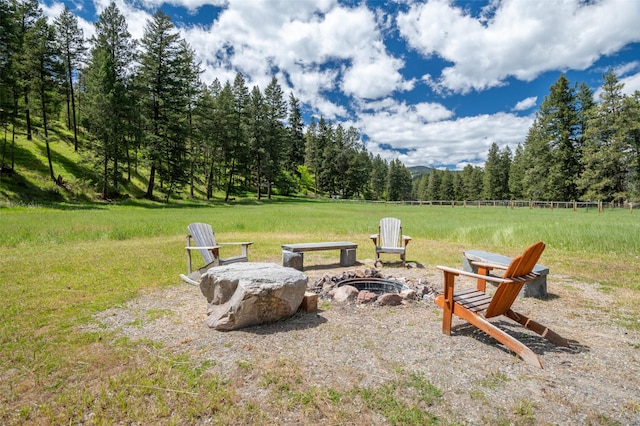 9995 Obrien Creek Rd, Missoula, MT 59804 - view of yard featuring an outdoor fire pit and a wooded view