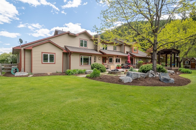 9995 Obrien Creek Rd, Missoula, MT 59804 - back of property featuring a lawn, an outdoor fire pit, and a patio area