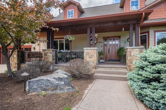 9995 Obrien Creek Rd, Missoula, MT 59804 - property entrance with a porch and roof with shingles