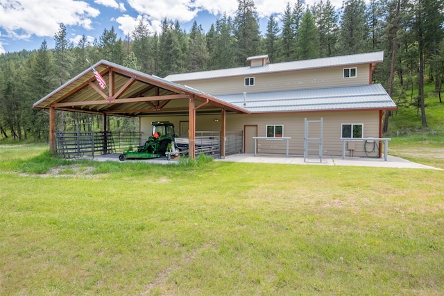 9995 Obrien Creek Rd, Missoula, MT 59804 - rear view of house with a carport, a metal roof, and a wooded view