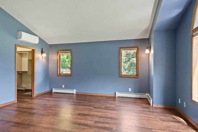 9995 Obrien Creek Rd, Missoula, MT 59804 - empty room with an AC wall unit, a baseboard radiator, lofted ceiling, and wood finished floors