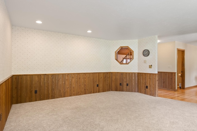 9995 Obrien Creek Rd, Missoula, MT 59804 - carpeted empty room featuring a wainscoted wall, wood walls, wallpapered walls, and recessed lighting