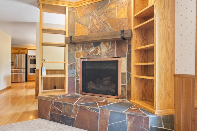 9995 Obrien Creek Rd, Missoula, MT 59804 - living room featuring wood finished floors, a fireplace, and built in features