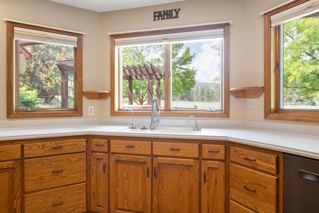 9995 Obrien Creek Rd, Missoula, MT 59804 - kitchen with healthy amount of natural light, light countertops, and brown cabinetry