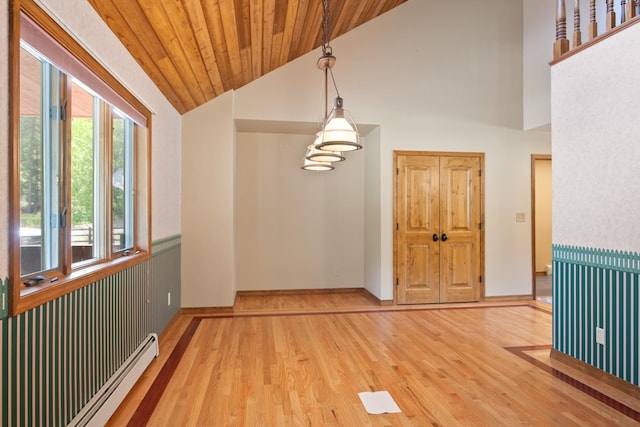 9995 Obrien Creek Rd, Missoula, MT 59804 - empty room featuring a baseboard radiator, wood finished floors, wood ceiling, and high vaulted ceiling