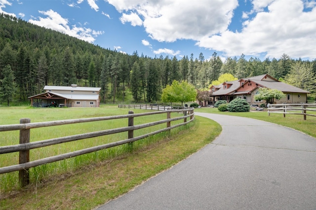 9995 Obrien Creek Rd, Missoula, MT 59804 - view of asphalt driveway featuring a wooded view