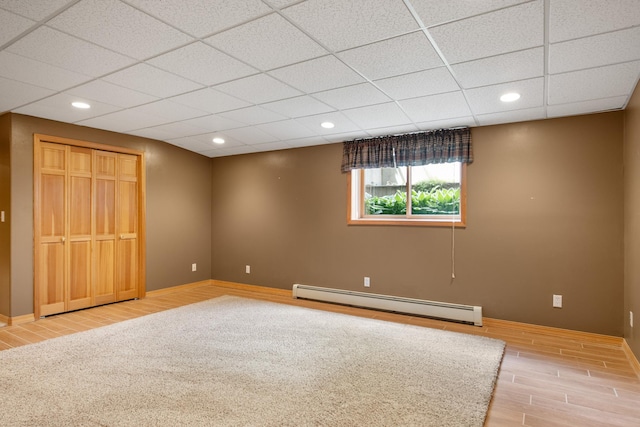 9995 Obrien Creek Rd, Missoula, MT 59804 - unfurnished bedroom featuring baseboard heating, wood finished floors, recessed lighting, a drop ceiling, and a closet