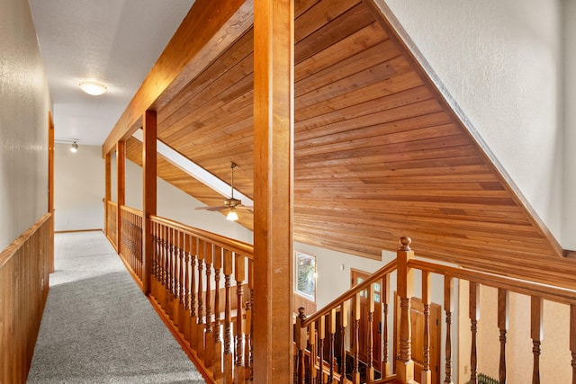 9995 Obrien Creek Rd, Missoula, MT 59804 - hall featuring carpet flooring, an upstairs landing, a textured wall, and lofted ceiling