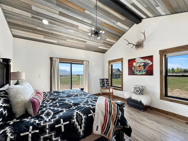 8 Montana Way, Ennis, MT 59729 - bedroom with wood finished floors, access to exterior, and a chandelier