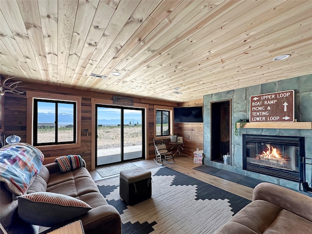 8 Montana Way, Ennis, MT 59729 - living room with plenty of natural light, wooden ceiling, wood walls, wood finished floors, and a tile fireplace