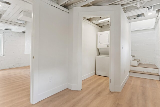 632 Stephens Ave, Missoula, MT 59801 - below grade area with estacked washer and dryer, light wood-type flooring, and stairway