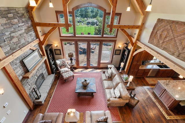 3 Antelope Ct, Clancy, MT 59634 - living area featuring dark wood-style floors, a fireplace, a towering ceiling, and french doors