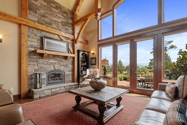 3 Antelope Ct, Clancy, MT 59634 - living area with a high ceiling, wood finished floors, and a stone fireplace