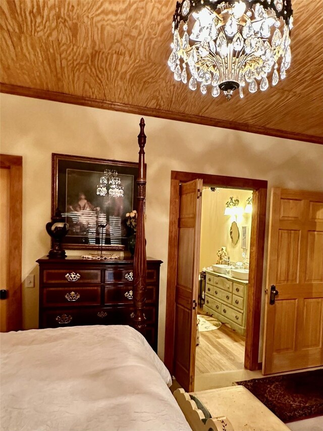 172 Hayfield Loop Trl, Ennis, MT 59729 - bedroom with ornamental molding, a chandelier, wood finished floors, and connected bathroom