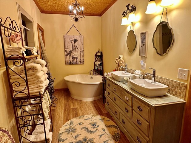 172 Hayfield Loop Trl, Ennis, MT 59729 - full bath featuring a soaking tub, double vanity, crown molding, wood finished floors, and tasteful backsplash