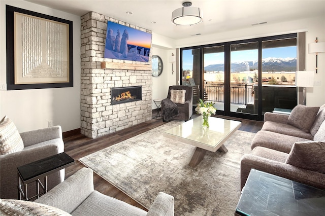 311E Akers Ln Unit E, Whitefish, MT 59937 - living area featuring wood finished floors and a stone fireplace