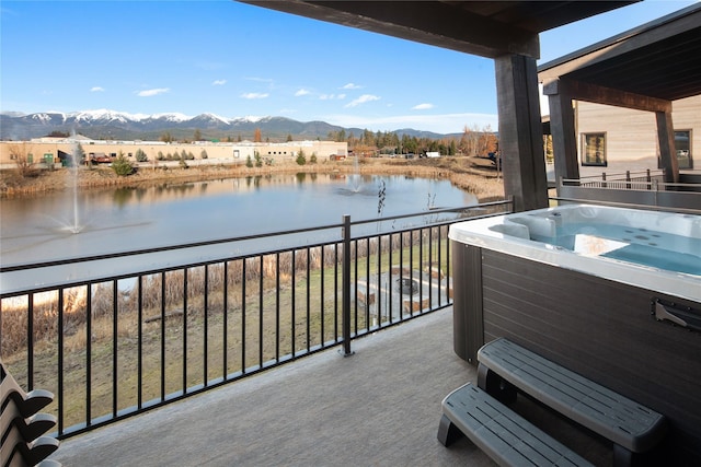 311E Akers Ln Unit E, Whitefish, MT 59937 - balcony featuring a water and mountain view and a hot tub
