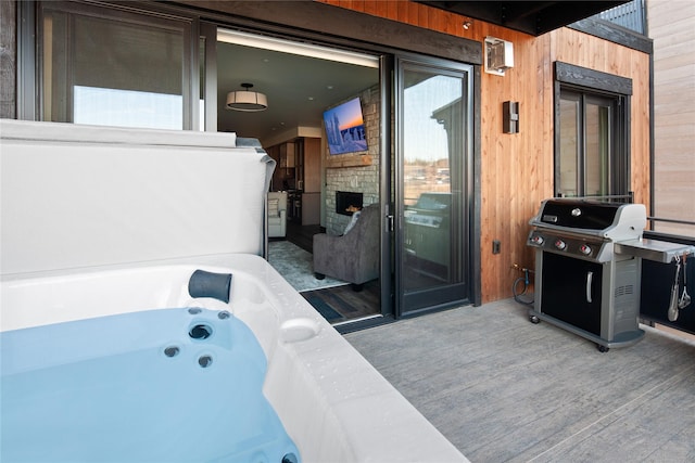 311E Akers Ln Unit E, Whitefish, MT 59937 - view of patio / terrace featuring grilling area and a hot tub
