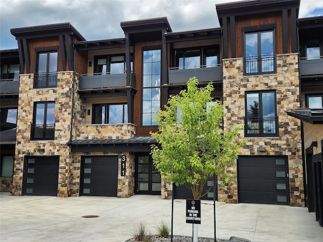 311E Akers Ln Unit E, Whitefish, MT 59937 - view of building exterior with a garage and driveway