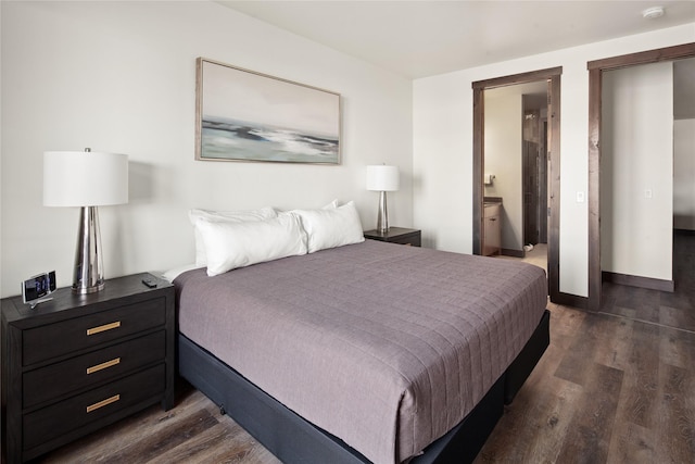 311E Akers Ln Unit E, Whitefish, MT 59937 - bedroom featuring dark wood-type flooring and ensuite bath