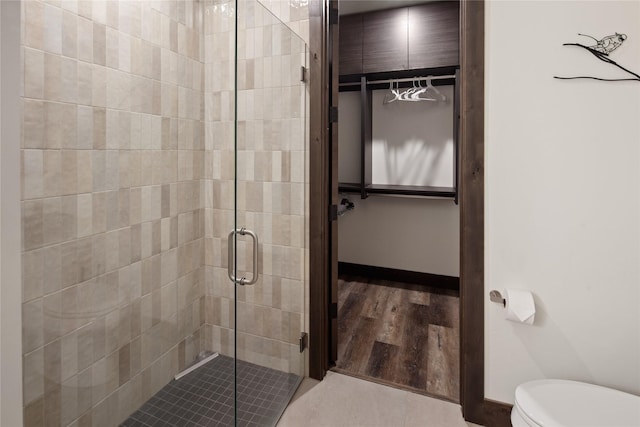 311E Akers Ln Unit E, Whitefish, MT 59937 - bathroom featuring a stall shower and wood finished floors