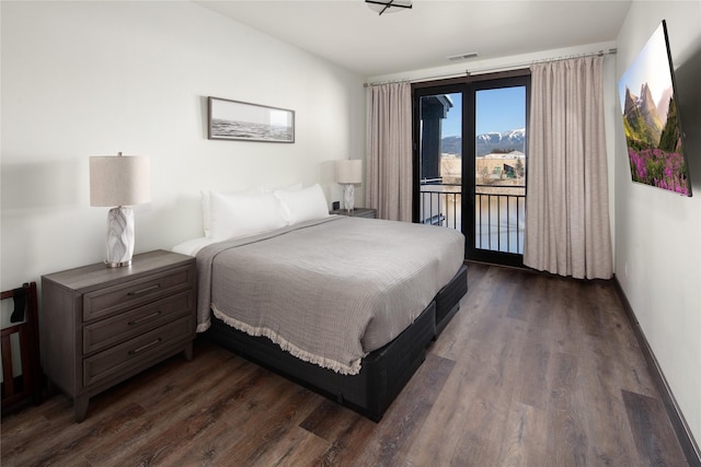 311E Akers Ln Unit E, Whitefish, MT 59937 - bedroom with access to outside and dark wood-style floors