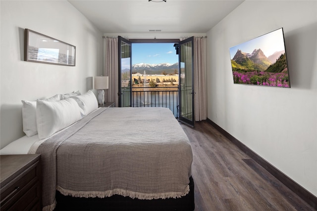 311E Akers Ln Unit E, Whitefish, MT 59937 - bedroom with dark wood finished floors and access to outside