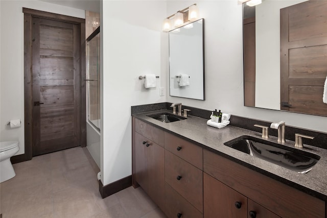 311E Akers Ln Unit E, Whitefish, MT 59937 - bathroom featuring double vanity, combined bath / shower with glass door, and tile patterned floors