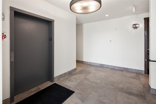311E Akers Ln Unit E, Whitefish, MT 59937 - empty room with elevator and baseboards
