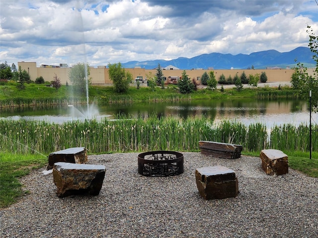 311E Akers Ln Unit E, Whitefish, MT 59937 - view of patio / terrace featuring an outdoor fire pit and a water and mountain view