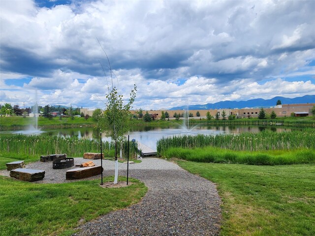 311E Akers Ln Unit E, Whitefish, MT 59937 - view of home's community featuring a water and mountain view, a lawn, and a fire pit