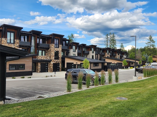 311E Akers Ln Unit E, Whitefish, MT 59937 - view of building exterior featuring a residential view and uncovered parking