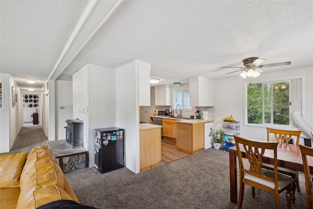 1970 Benchmark Ln, Whitefish, MT 59937 - kitchen with a textured ceiling, light carpet, light countertops, ceiling fan, and healthy amount of natural light
