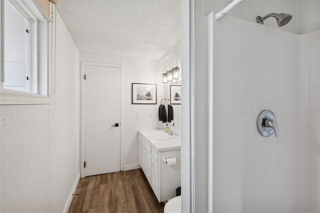 1970 Benchmark Ln, Whitefish, MT 59937 - full bathroom with a shower, vanity, wood finished floors, and a textured ceiling