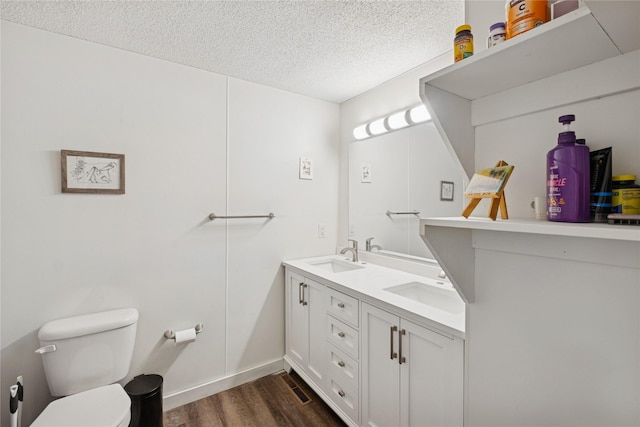 1970 Benchmark Ln, Whitefish, MT 59937 - bathroom featuring a textured ceiling, wood finished floors, and double vanity