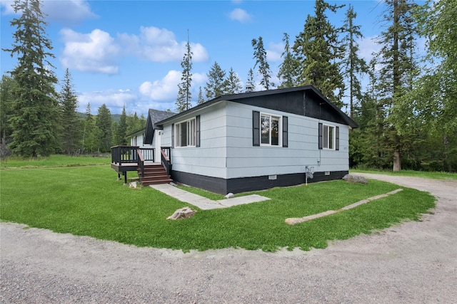 1970 Benchmark Ln, Whitefish, MT 59937 - view of front of house featuring crawl space, a front yard, and a wooden deck