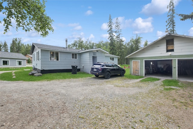 1970 Benchmark Ln, Whitefish, MT 59937 - view of property exterior featuring dirt driveway and a detached garage