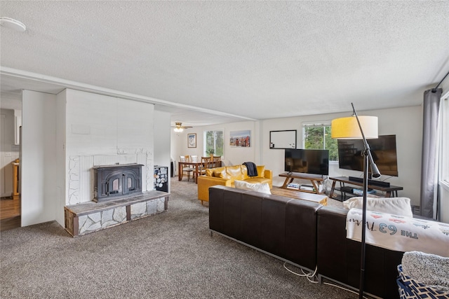 1970 Benchmark Ln, Whitefish, MT 59937 - carpeted living room featuring a textured ceiling and a fireplace with raised hearth