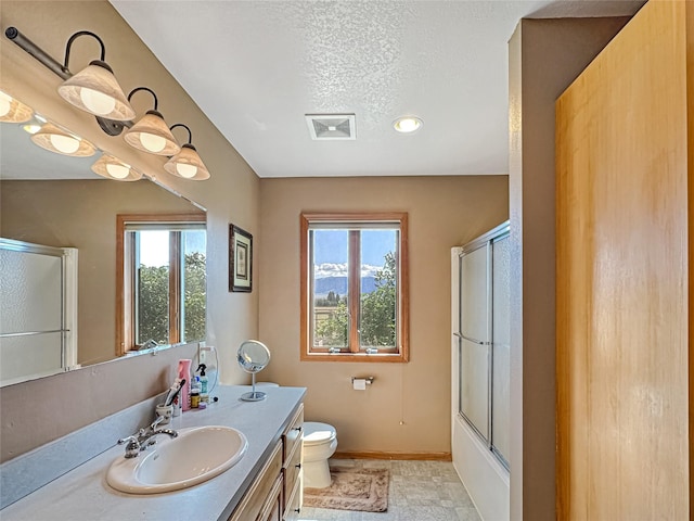 2 Hardy Cir, Ennis, MT 59729 - bathroom featuring vanity, a textured ceiling, recessed lighting, and combined bath / shower with glass door